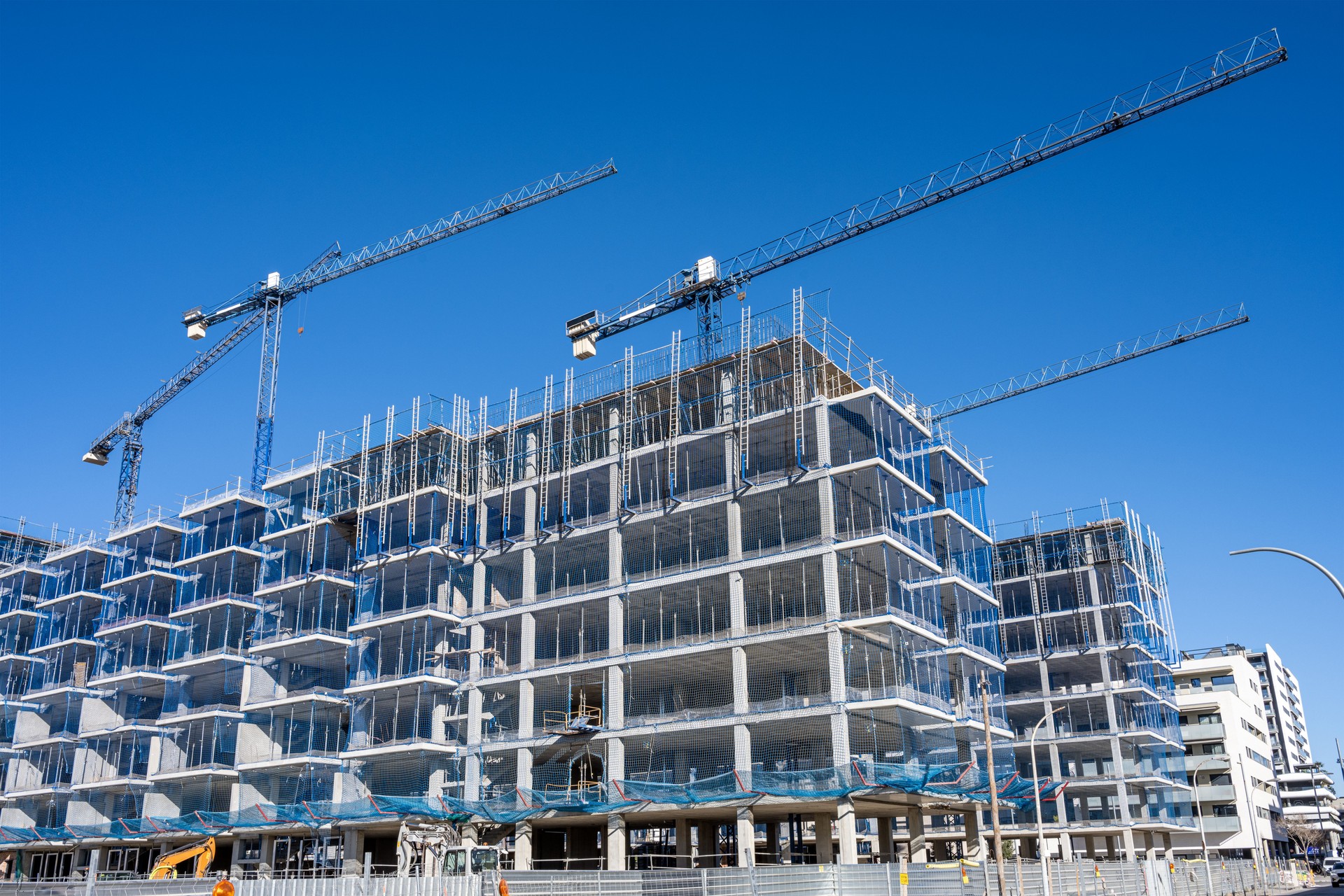 Construction site with cranes for residential buildings